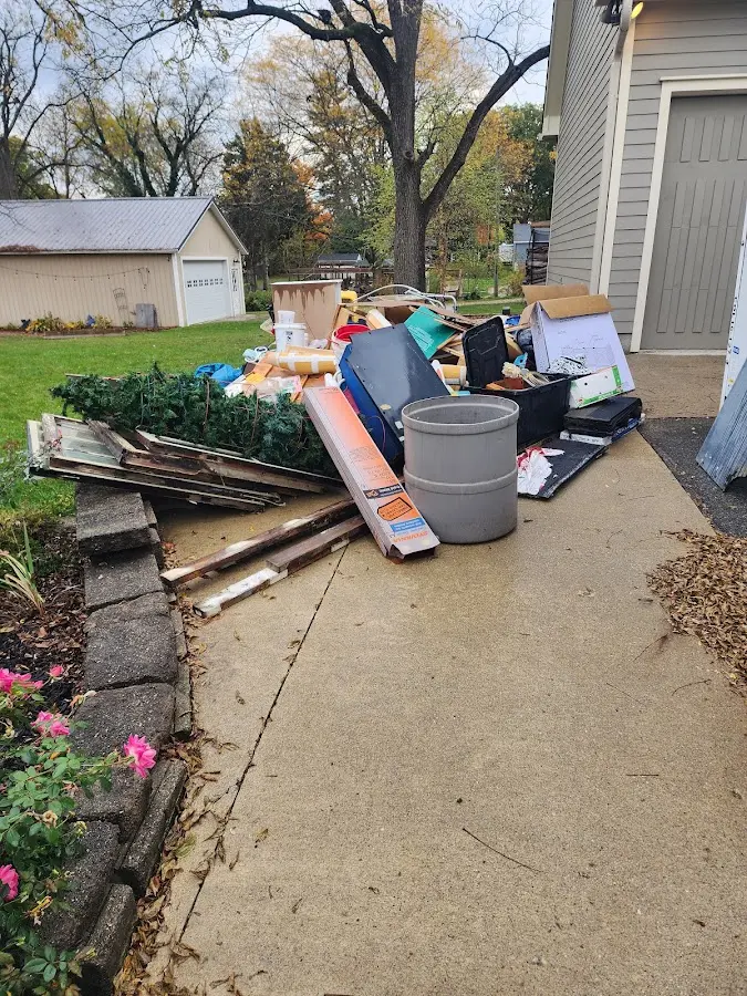 Dumpster being loaded with debris for Roofing Dumpster Rental in Prospect Heights